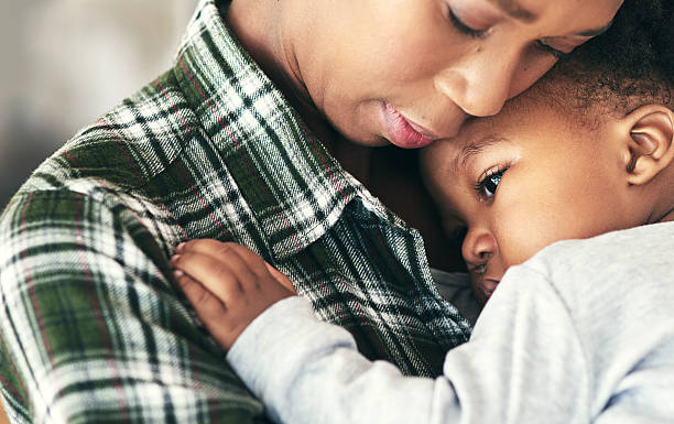 A worried mother holding her baby