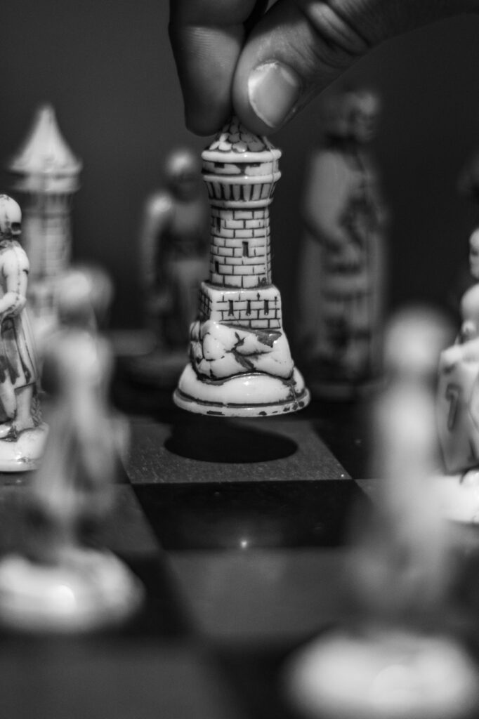 Black and white chess scene with a rook being strategically moved on the board.
