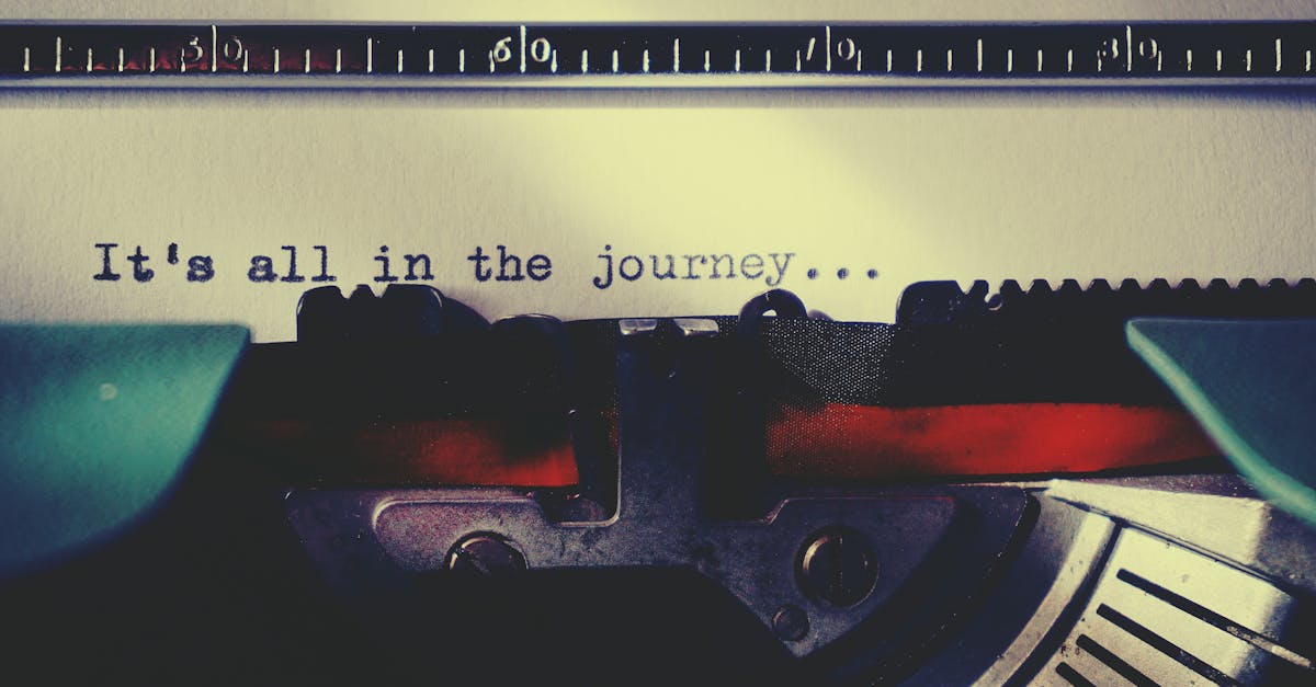 Close-up of a vintage typewriter typing an inspirational quote about the journey.