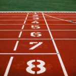 Close-up view of an athletic race track with numbered lanes, ready for competition.